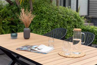 Panama dark rectangular table and 6 Nassau black aluminum dining chairs on patio on Tampa Home & Garden Store