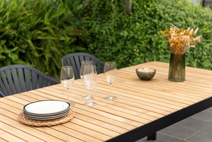 Portals dark rectangular teak table with 6 Nassau black aluminum dining chairs outdoor set on Tampa Home & Garden Store
