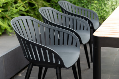 Portals dark rectangular teak table with 6 Nassau black aluminum chairs set on Tampa Home & Garden Store