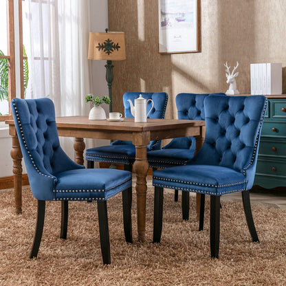 Set of 4 blue velvet tufted dining chairs with nailhead trim and dark wooden legs on Tampa Home & Garden Store