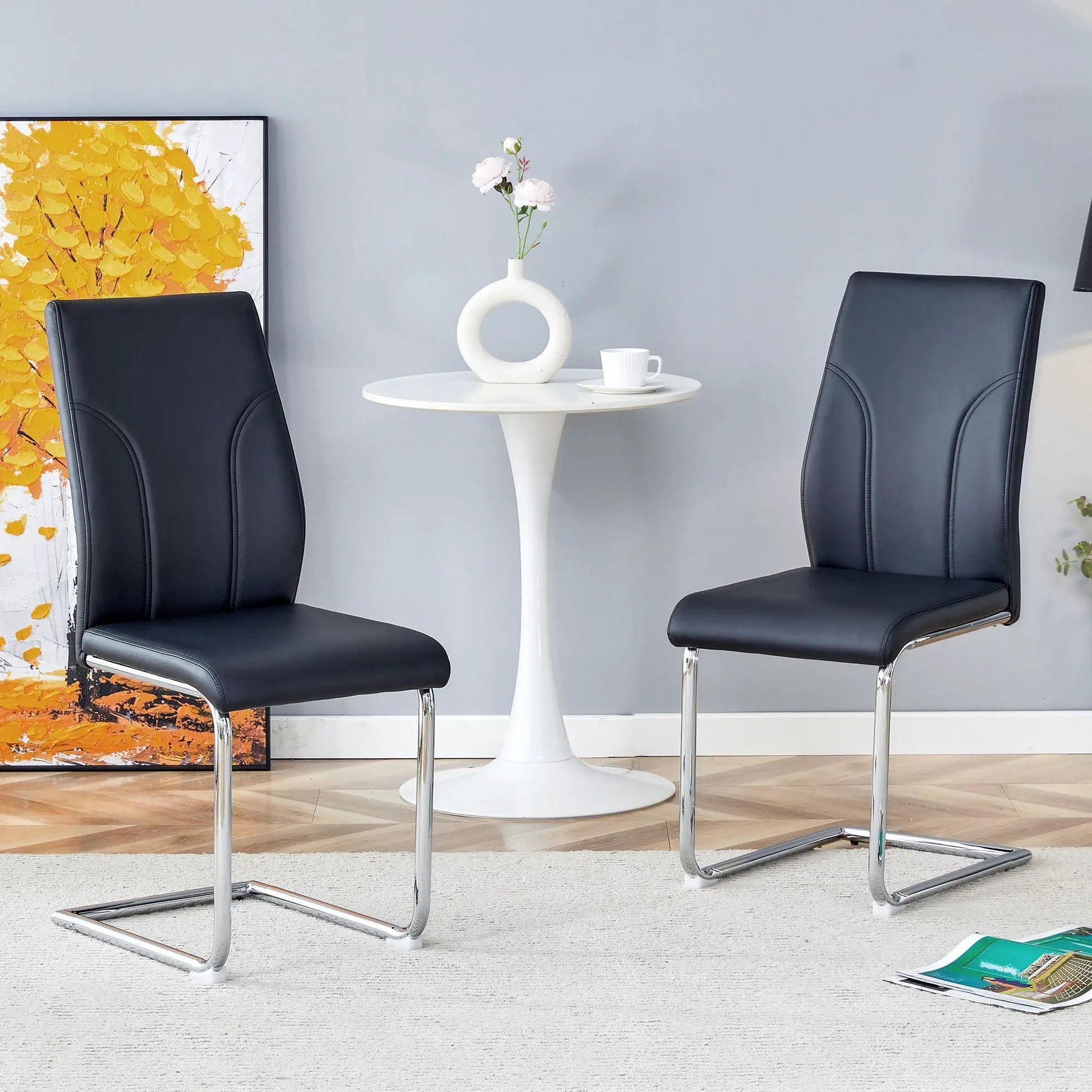 Two black high-back dining chairs with chrome cantilever legs around a white table Unique Piece on Tampa Home & Garden Store