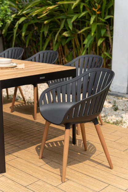 Portals dark rectangular teak dining table with eight Nassau black chairs set on Tampa Home & Garden Store