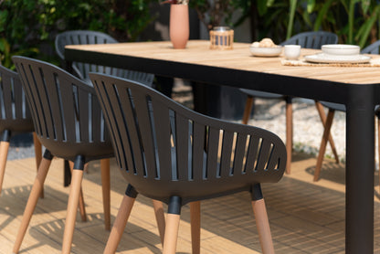 Portals dark rectangular teak outdoor table with 8 Nassau black dining chairs for patio dining set on Tampa Home & Garden Store
