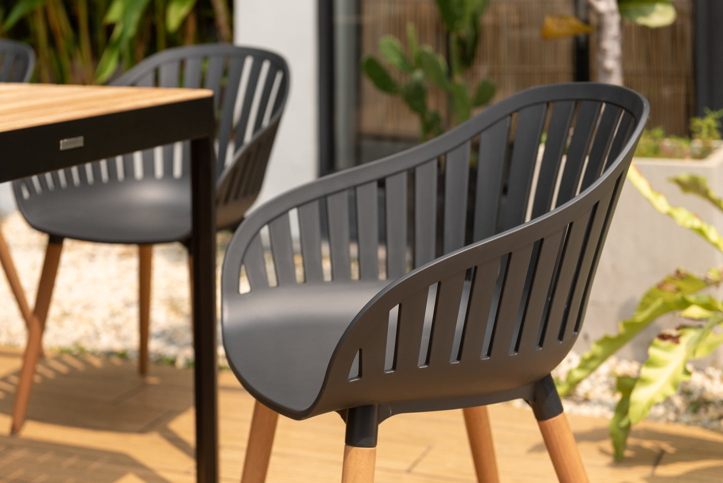 Portals dark rectangular teak table with 8 Nassau black dining chairs outdoor patio set on Tampa Home & Garden Store