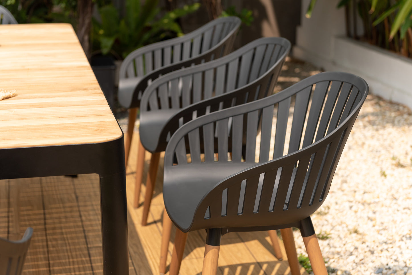Portals dark rectangular teak outdoor table with 8 Nassau black dining chairs on Tampa Home & Garden Store