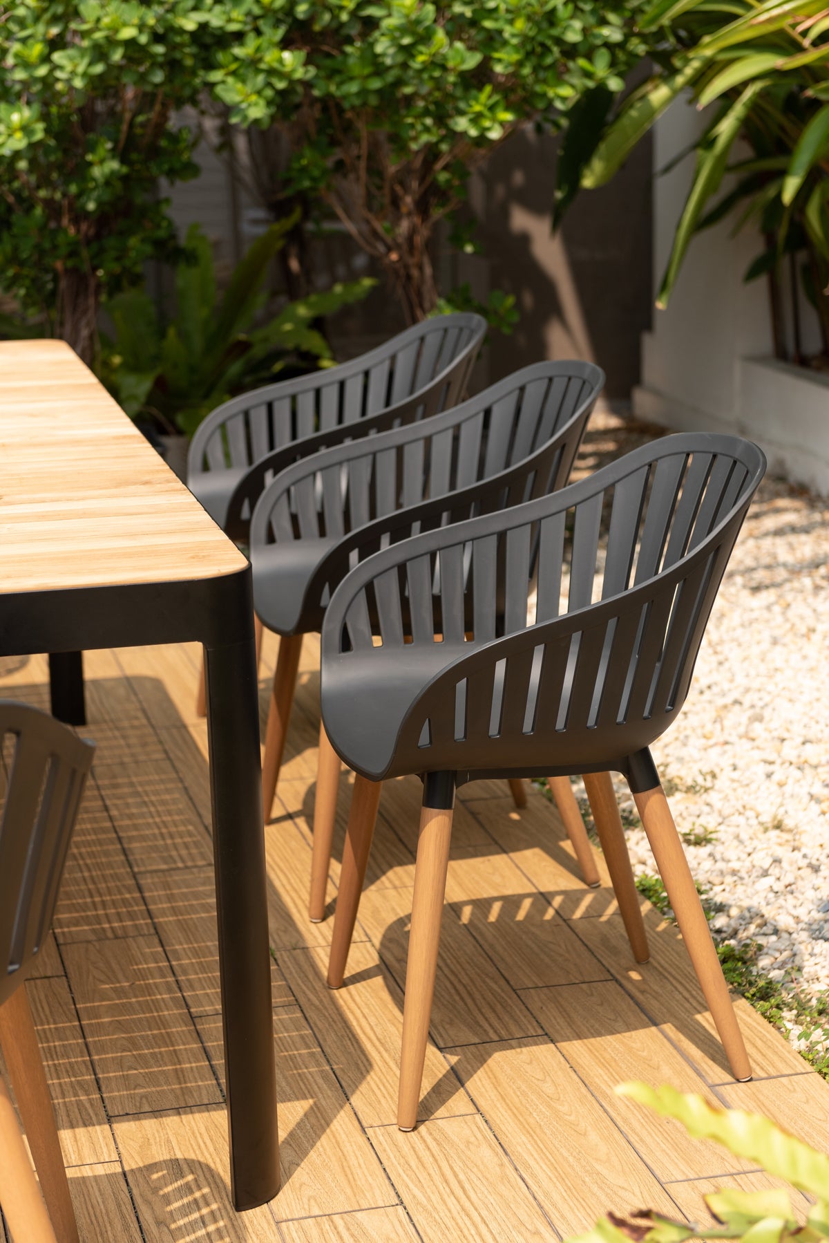 Portals dark rectangular teak table with eight Nassau black dining chairs outdoor dining set on Tampa Home & Garden Store