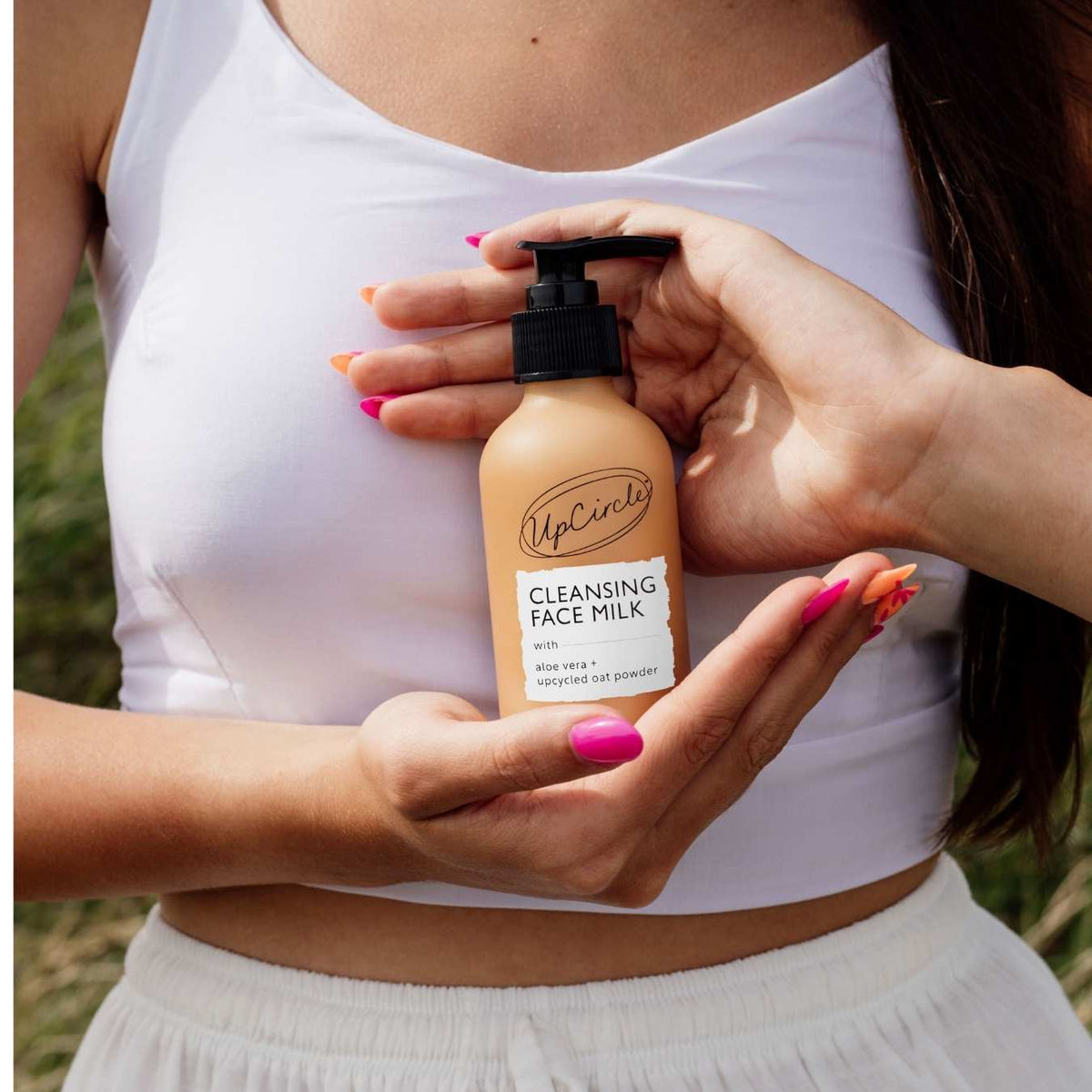 Cleansing Face Milk bottle by UpCircle, beige pump with white label and aloe vera + oat powder on Tampa Home & Garden Store