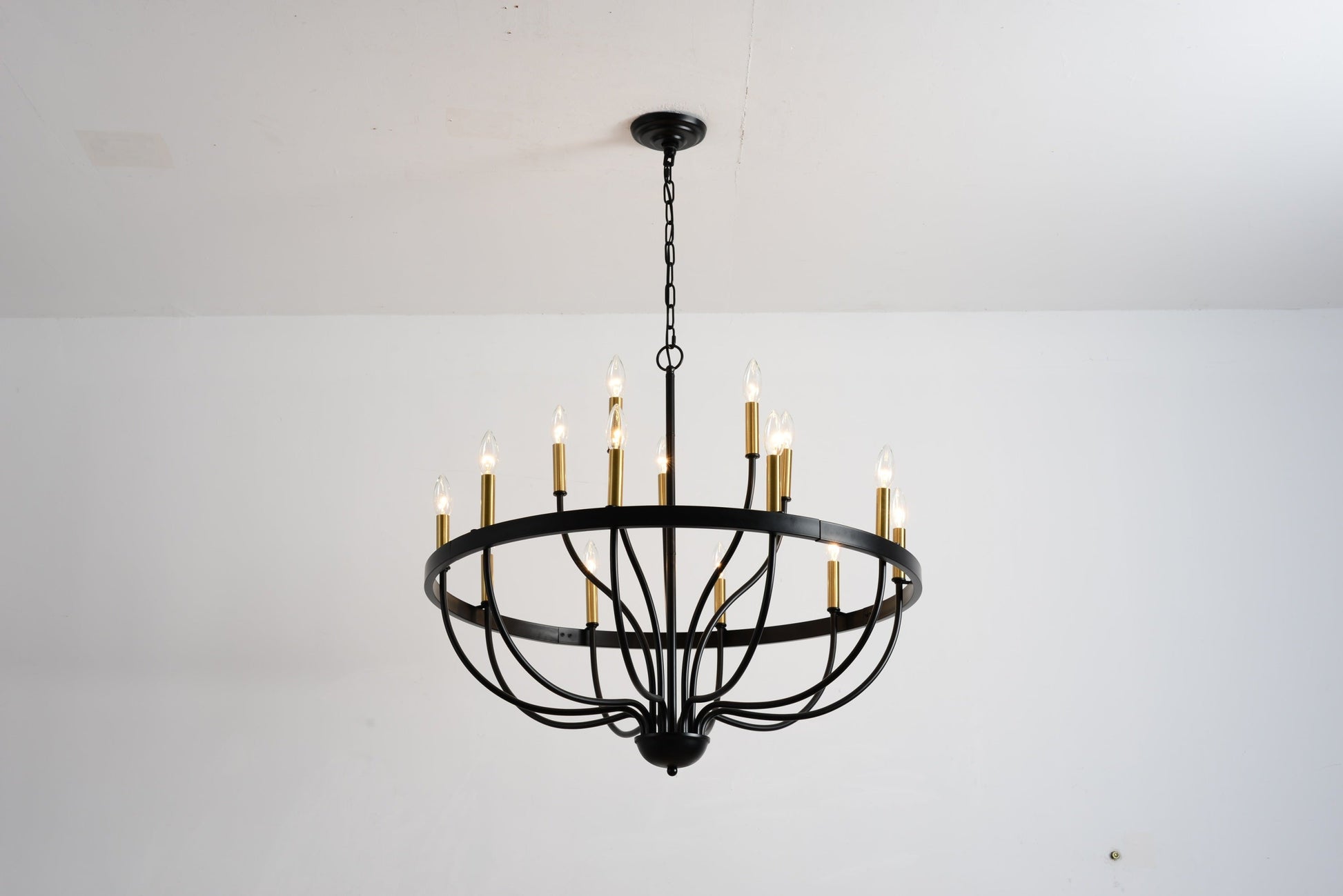 18-Light industrial iron chandelier with black frame, brass candle cups, hung by chain on Tampa Home & Garden Store