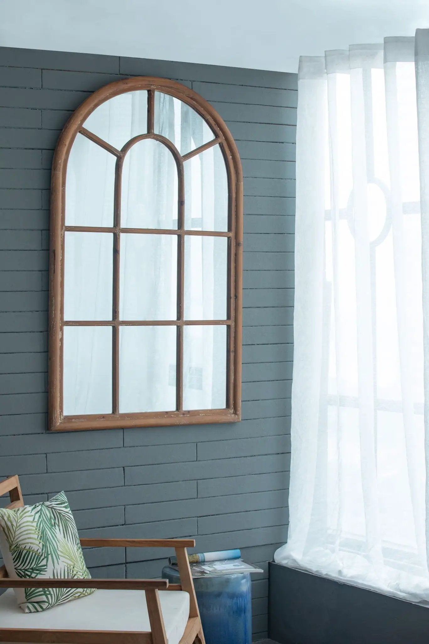 Large arched accent mirror with distressed brown fir wood frame and grid window design on Tampa Home & Garden Store