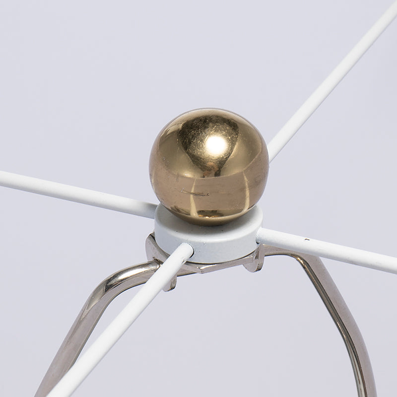 Table lamp with round gold ball finial atop white tripod frame on Tampa Home & Garden Store