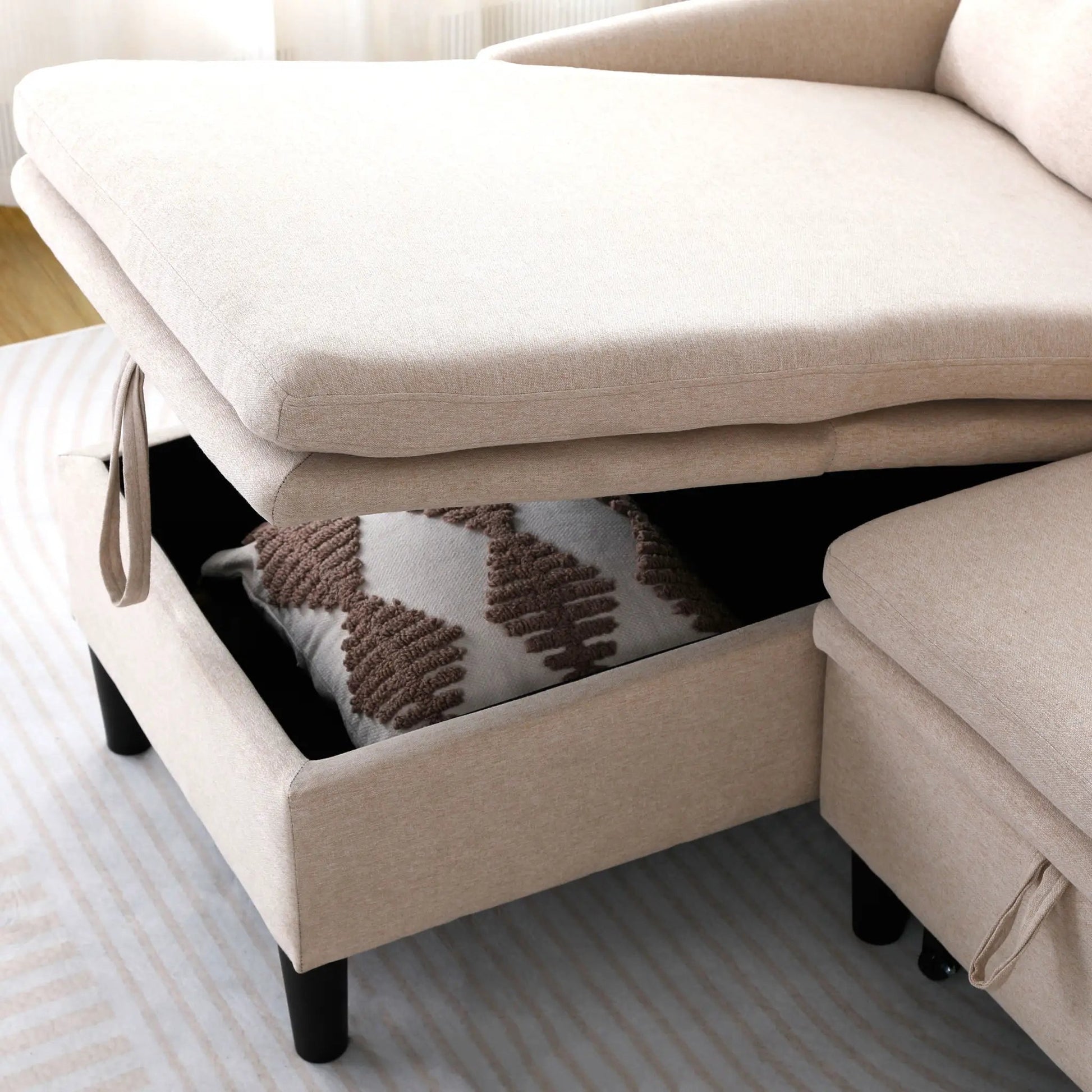 L-shaped reversible chaise sectional sofa in beige fabric with black legs on Tampa Home & Garden Store