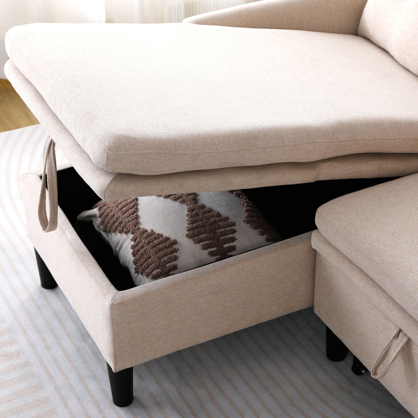 Beige fabric L-shaped reversible chaise sleeper sectional with storage and black legs on Tampa Home & Garden Store