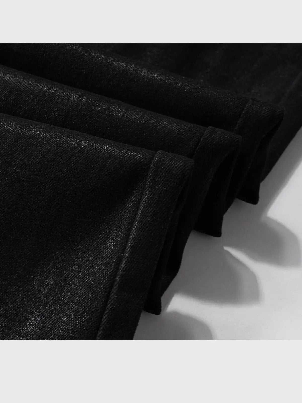 Men's vinyl-coated bootcut trousers in black denim-like fabric with visible stitching on Tampa Home & Garden Store