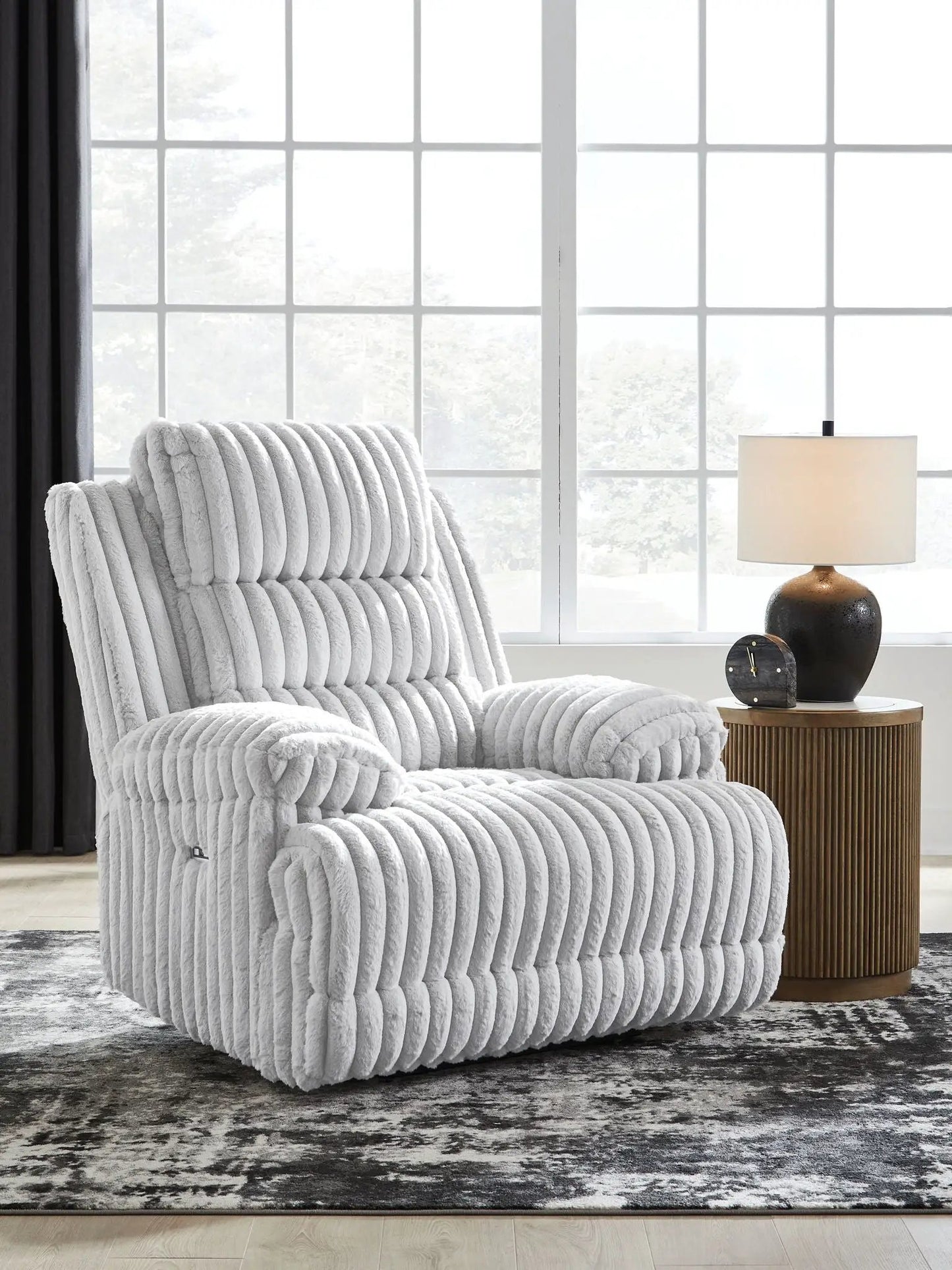 Rhines Falls Alloy Zero Wall Recliner in plush grey upholstery beside a round table lamp on Tampa Home & Garden Store
