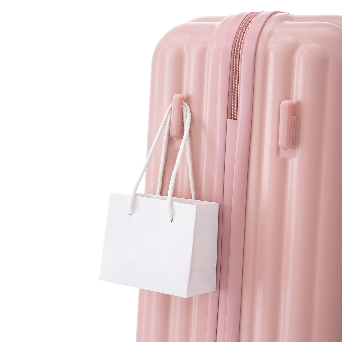 3-piece pink hard-shell spinner luggage set with white shopping bag on Tampa Home & Garden Store