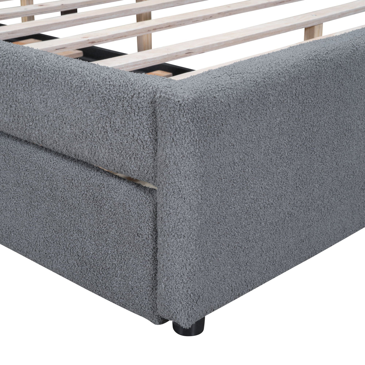 Upholstered platform bed in grey boucle fabric with exposed wooden slat base on Tampa Home & Garden Store