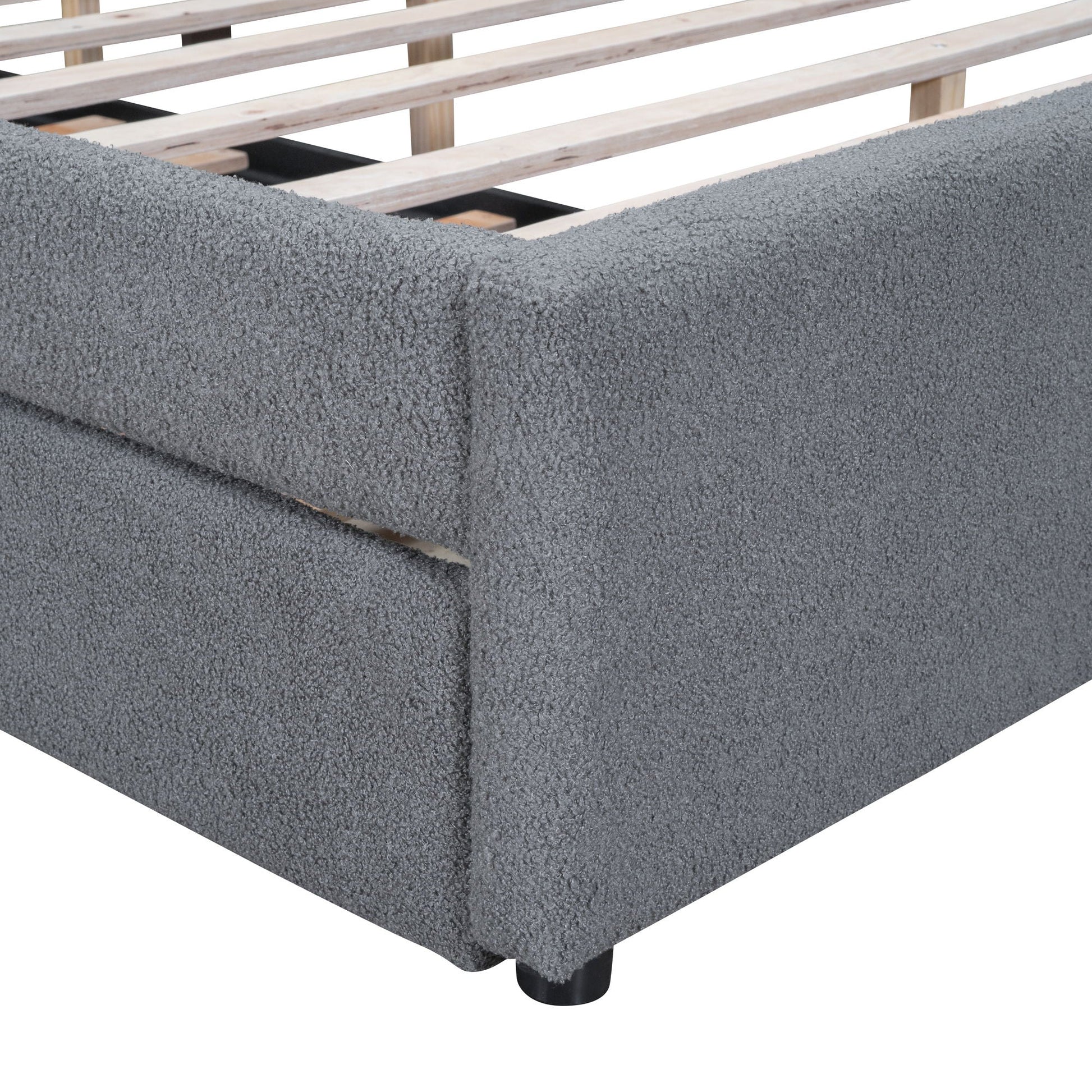 Upholstered platform bed in grey boucle fabric with exposed wooden slat base on Tampa Home & Garden Store