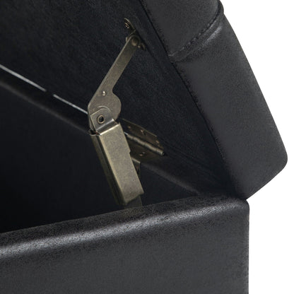Harrison tufted lift-top storage ottoman in dark upholstery with visible metal hinge on Tampa Home & Garden Store