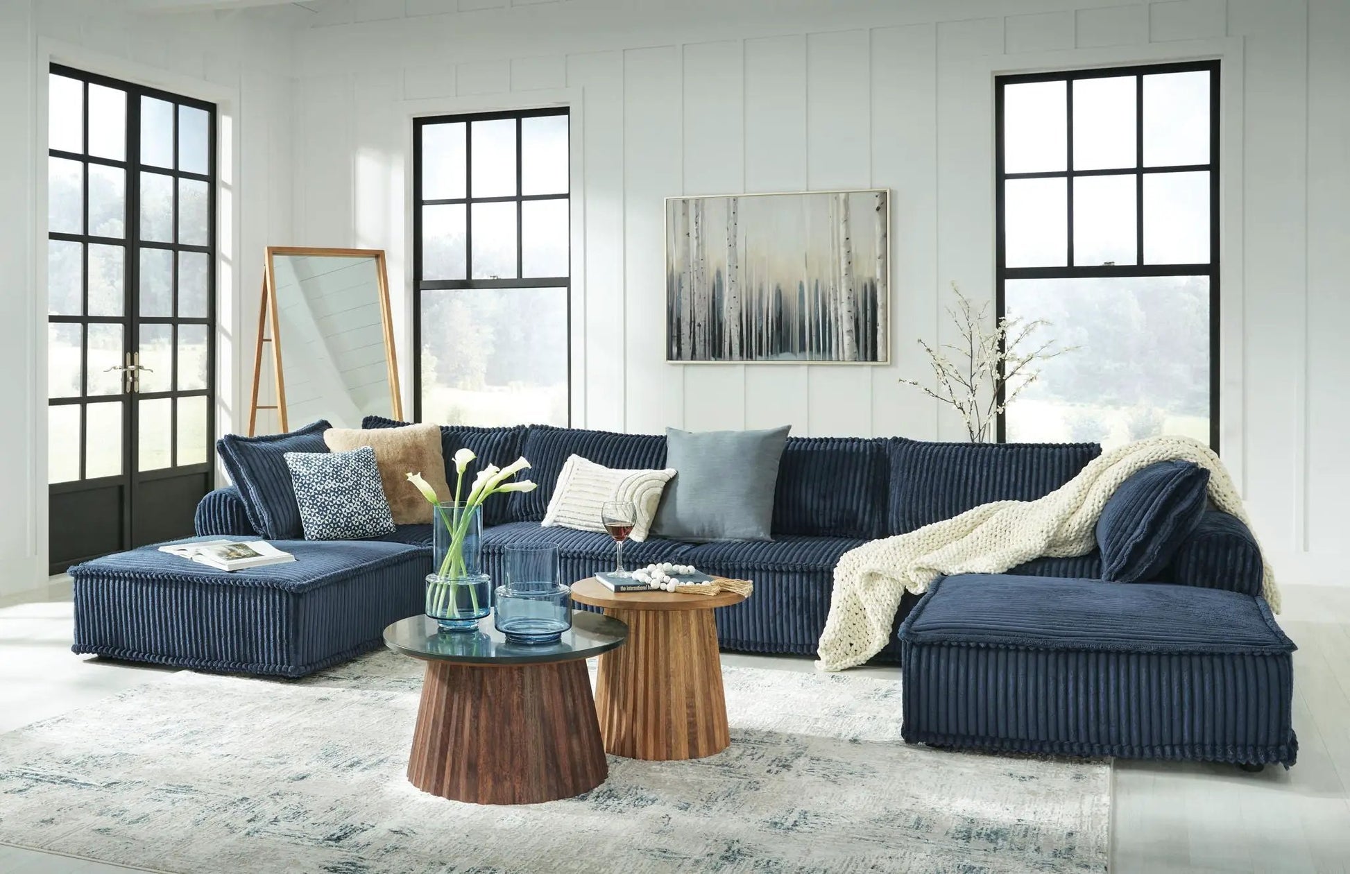 Bales - Sectional navy blue corduroy sofa in a bright modern living room on Tampa Home & Garden Store