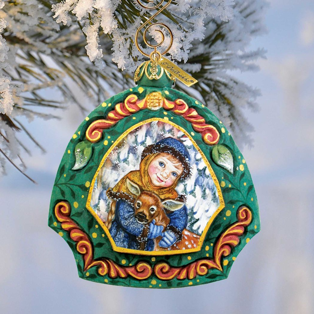 Girl with Deer sculpted hand-painted Christmas ornament by G. DeBrekht in a green ornate frame on Tampa Home & Garden Store