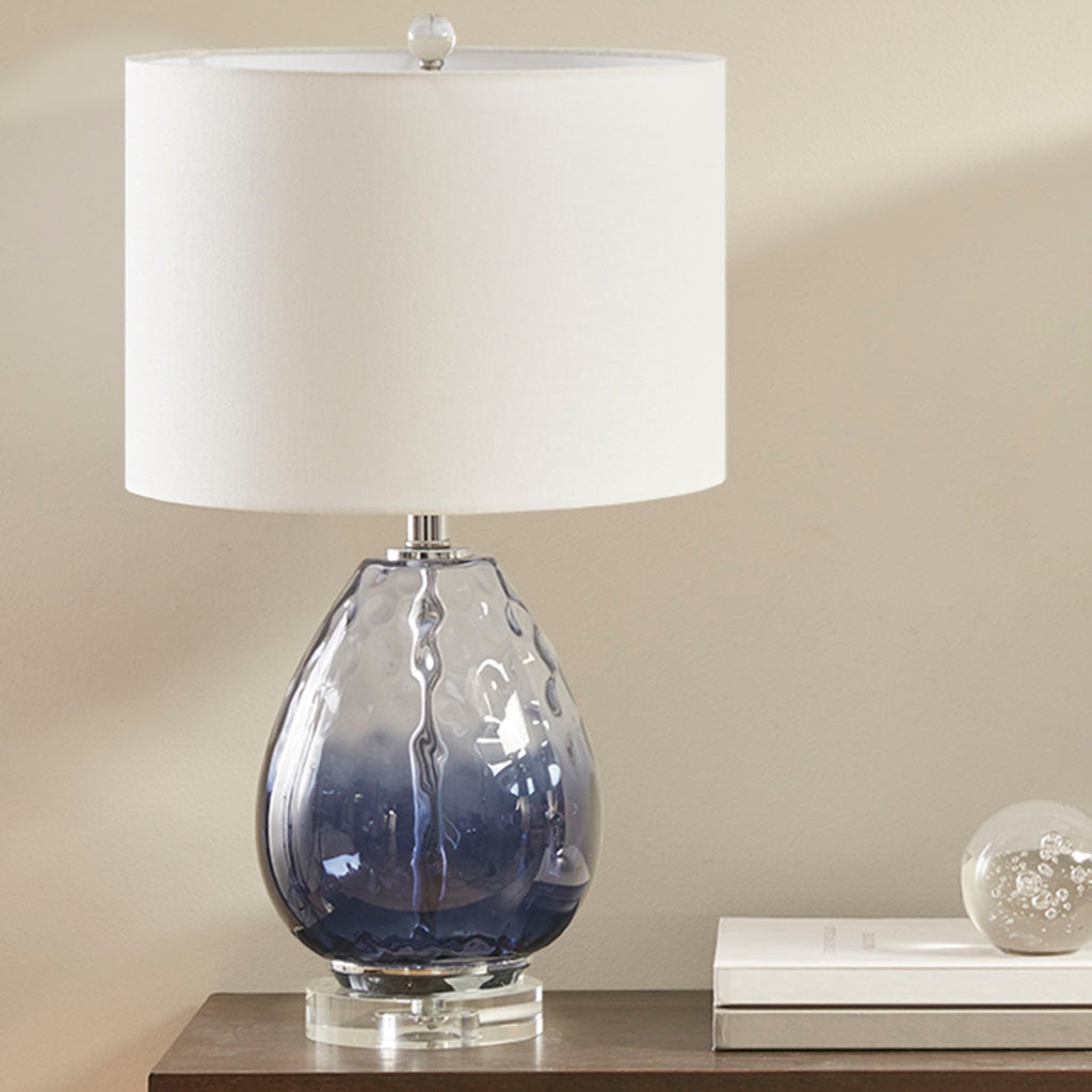 Ombre blue glass table lamp with white drum shade on a wooden table on Tampa Home & Garden Store