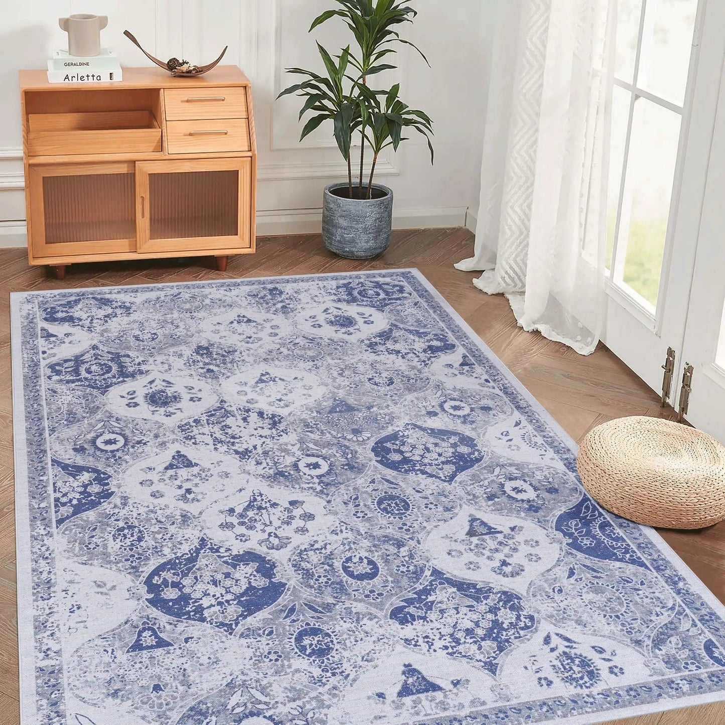 Maval area rug in blue and white with ornate pattern in a bright living room beside a cabinet on Tampa Home & Garden Store
