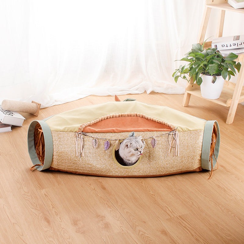 Four Seasons cat tunnel bed by Sell My Stuff in tan woven fabric with teal ends and cat peeking on Tampa Home & Garden Store