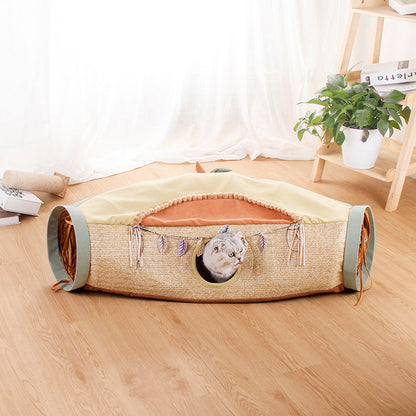 Four Seasons cat tunnel bed by Sell My Stuff in tan woven fabric with teal ends and cat peeking on Tampa Home & Garden Store