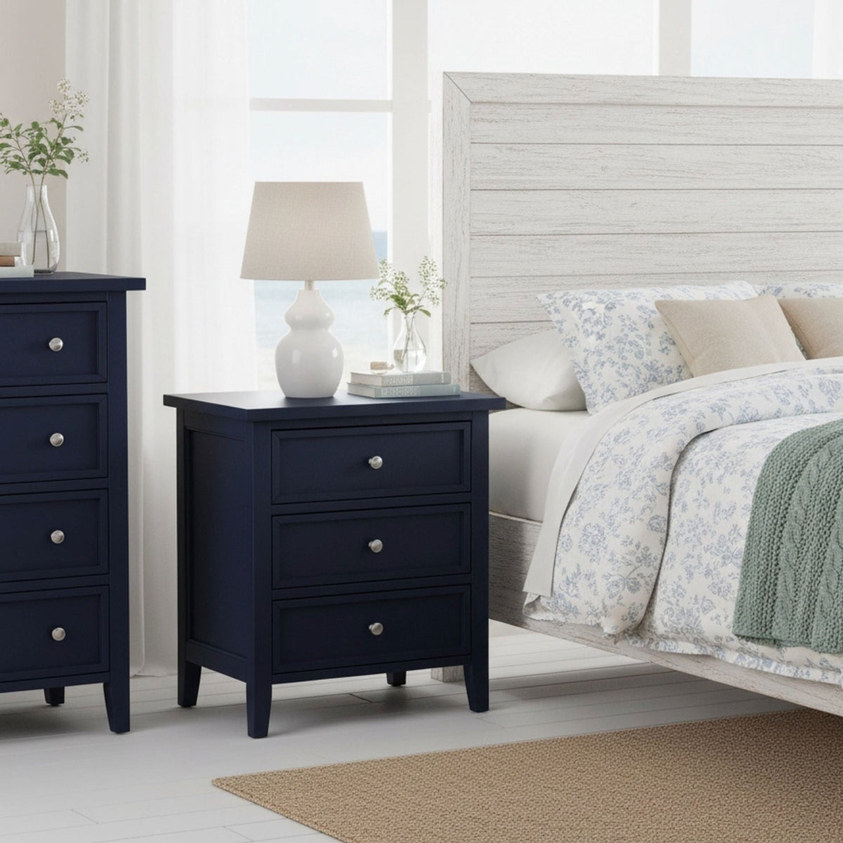 Set of 2 3-drawer accent nightstands with metal glides in navy blue beside a bed in a modern bedroom on Tampa Home & Garden Store