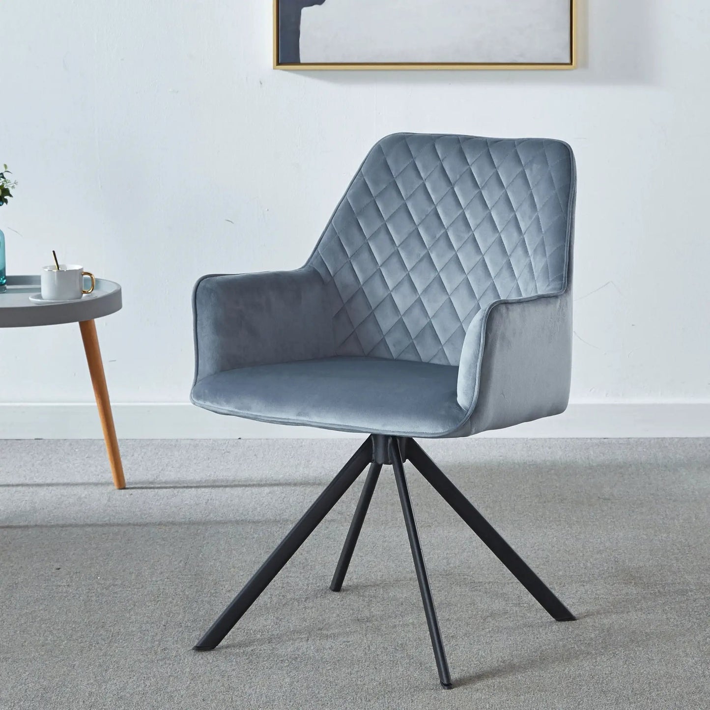 Blue quilted upholstered swivel desk chair with a black metal four-legged base on Tampa Home & Garden Store