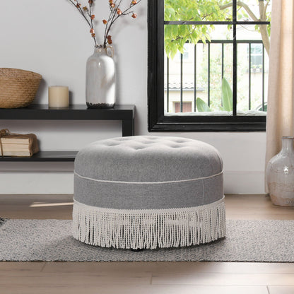 Yolanda round grey upholstered ottoman with white fringe trim in modern living space on Tampa Home & Garden Store