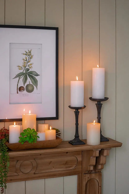 Unscented soy wax set of 2 white pillar candles on a mantel with black metal holders on Tampa Home & Garden Store