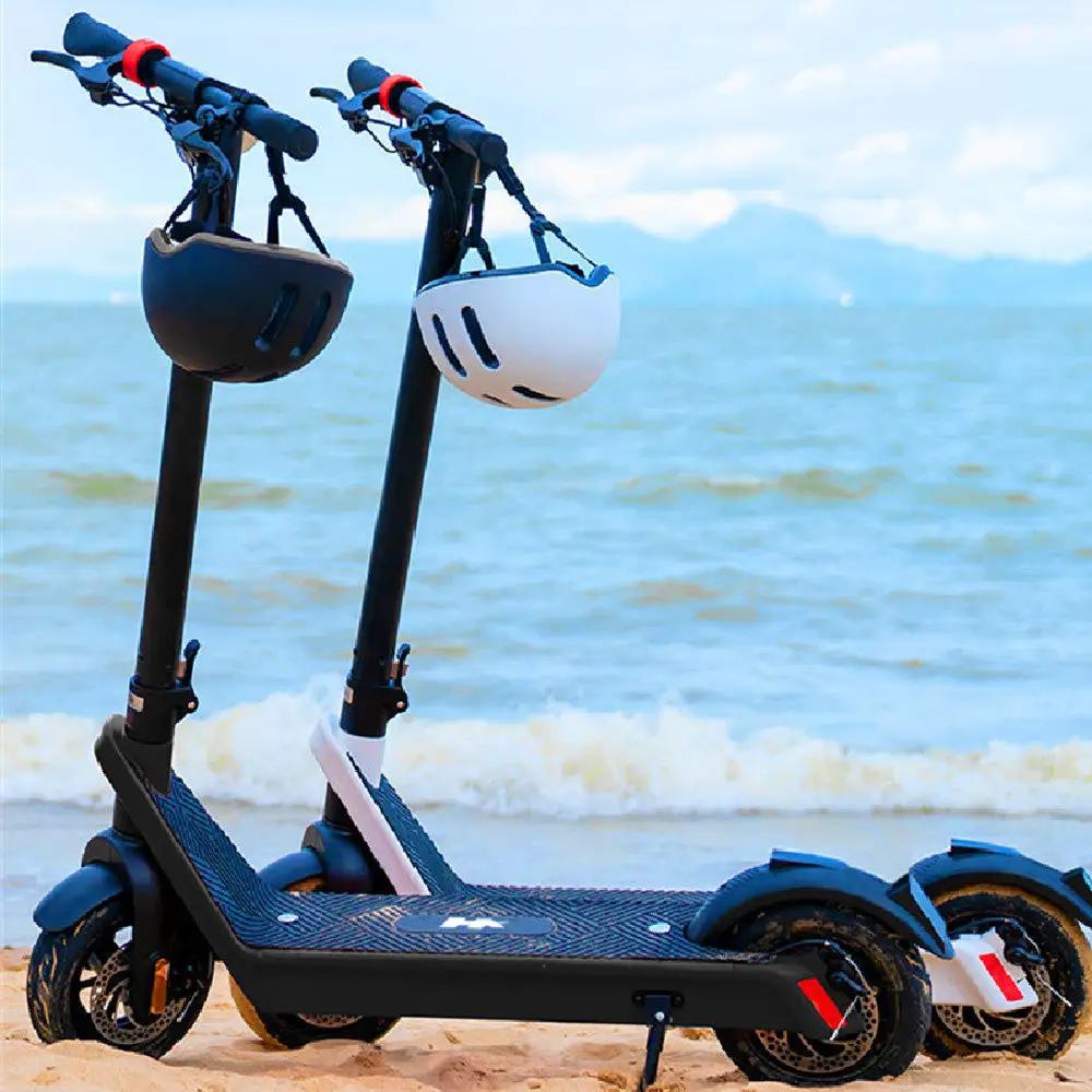 Electric Scooter X9 Endurance with 10in wheels and helmets on handlebars at beach on Tampa Home & Garden Store