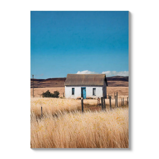Canvas Art white house in a natural rural field with blue doors and windows under a blue sky on Tampa Home & Garden Store