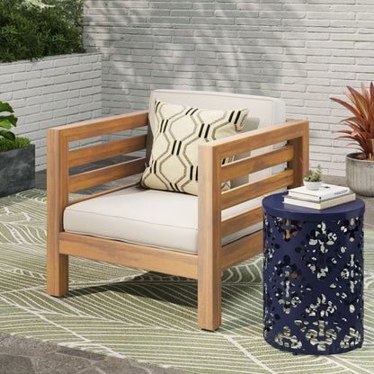 Outdoor Acacia wood patio armchair with white fabric cushion and patterned throw pillow on Tampa Home & Garden Store