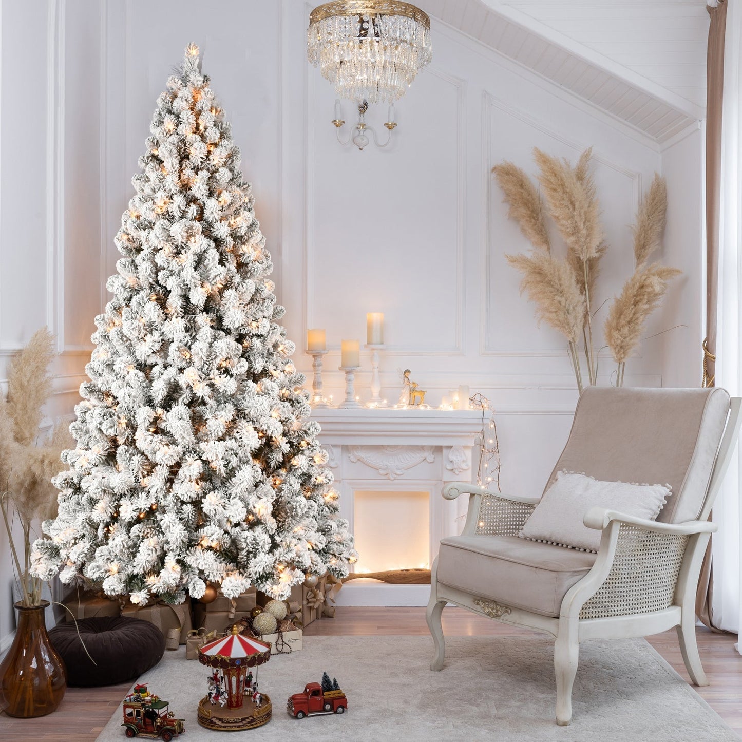 9-Foot Pre-Lit Snow-Flocked Christmas Tree by HouseOfZazla with warm white lights in a white living room on Tampa Home & Garden Store