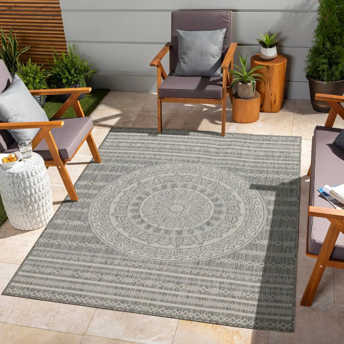 Sunshine indoor/outdoor polypropylene area rug in gray with mandala pattern on patio on Tampa Home & Garden Store