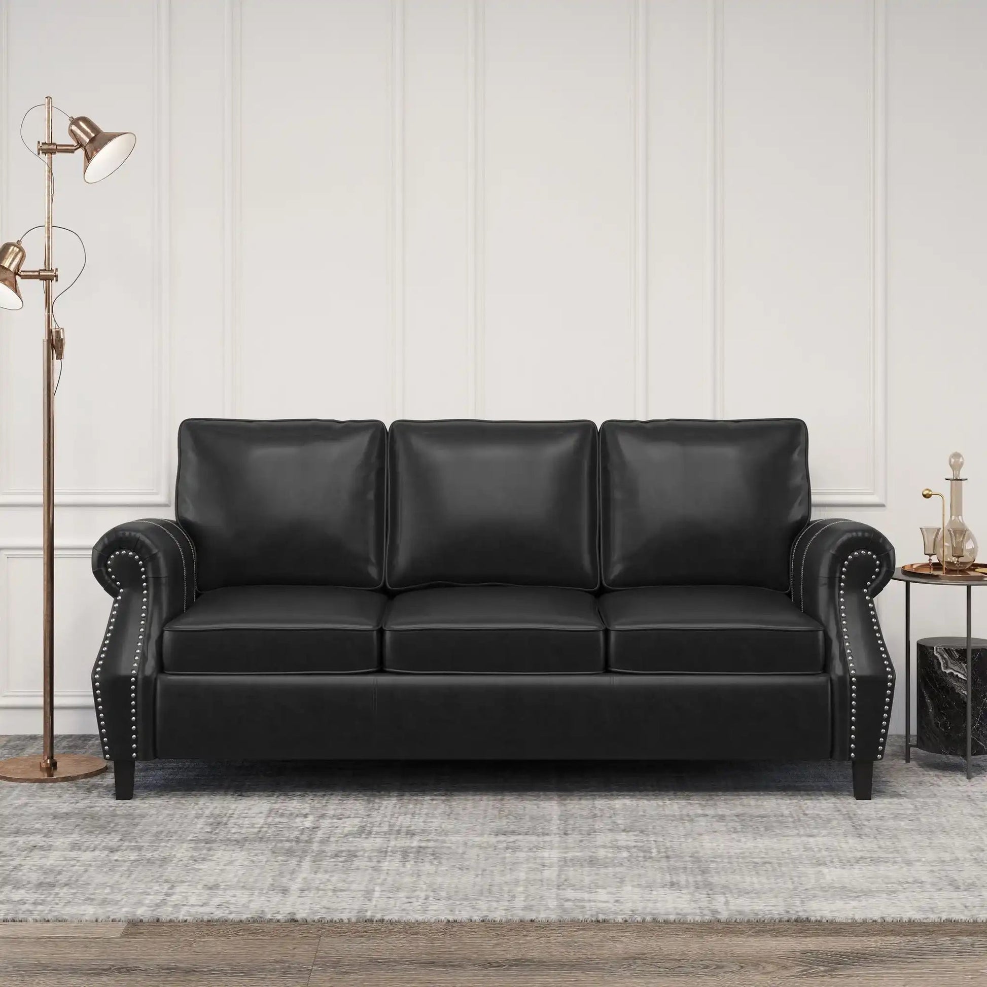 Contemporary 3 Seater Sofa with Nailhead Trim, black leather against white paneled wall on Tampa Home & Garden Store