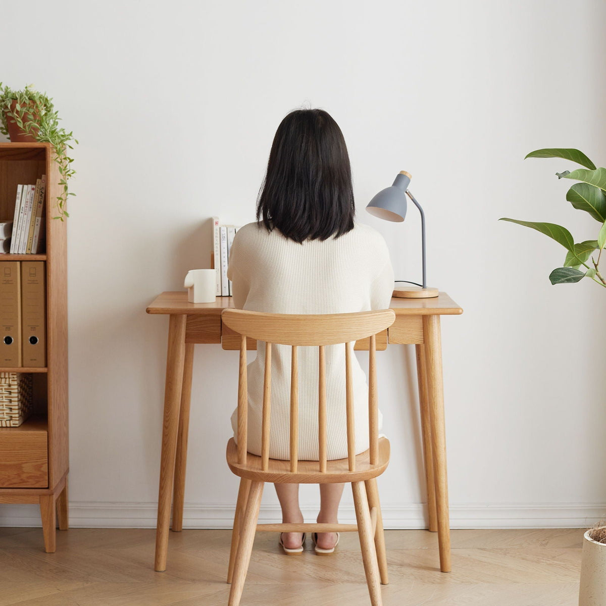 Oak computer desk with drawer in natural wood finish; wooden chair, desk lamp, and plants on Tampa Home & Garden Store