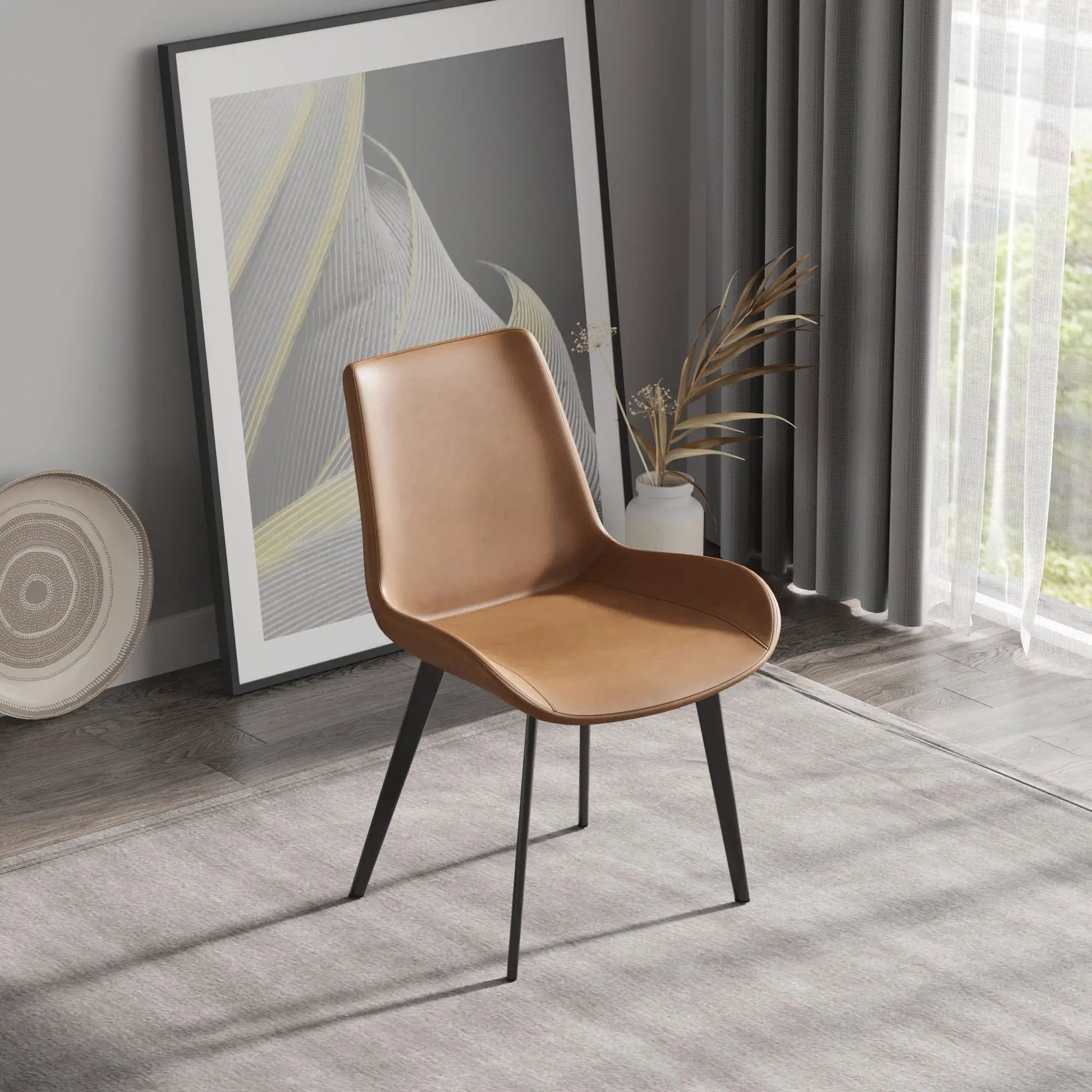 Modern dining chair set of 2 with tan leather seat and black metal legs in a living room on Tampa Home & Garden Store