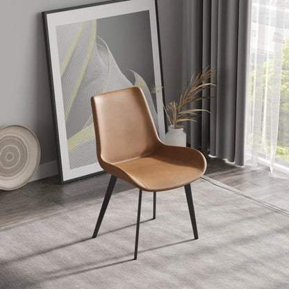 Modern dining chair set of 2 with tan leather seat and black metal legs in a living room on Tampa Home & Garden Store