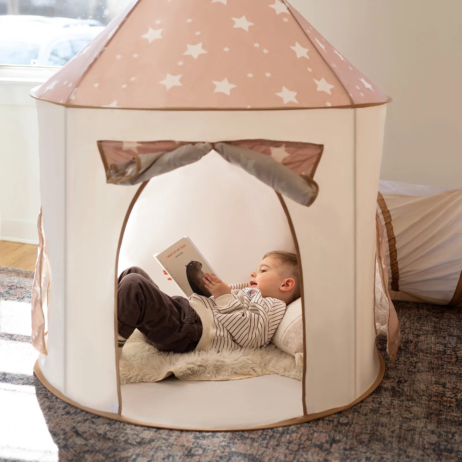 Tiny Land Play Tunnel 3-in-1 pink star canopy, white body; child reading inside on Tampa Home & Garden Store