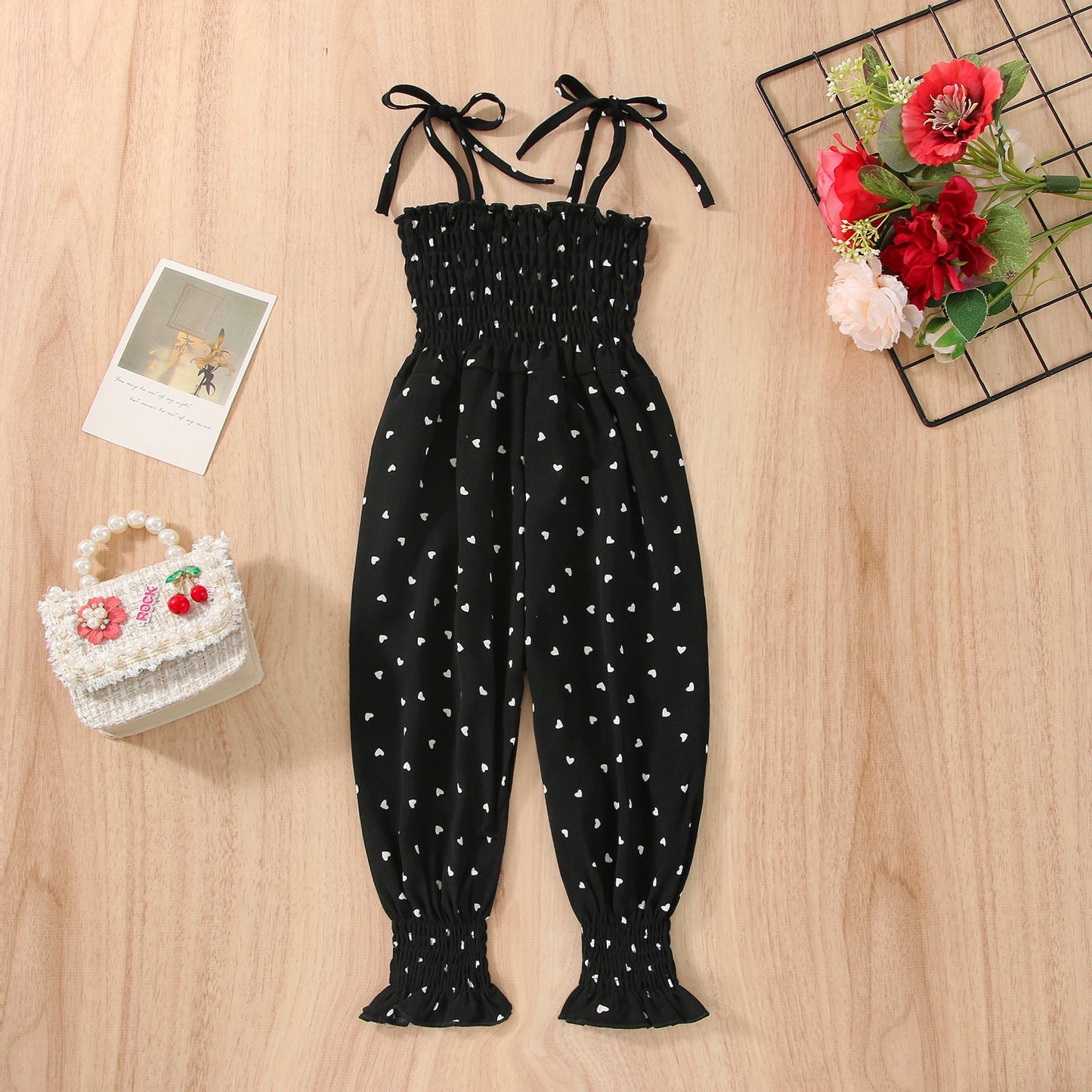 Stevvex baby sleeveless black romper with white heart print, smocked bodice, adjustable straps on Tampa Home & Garden Store