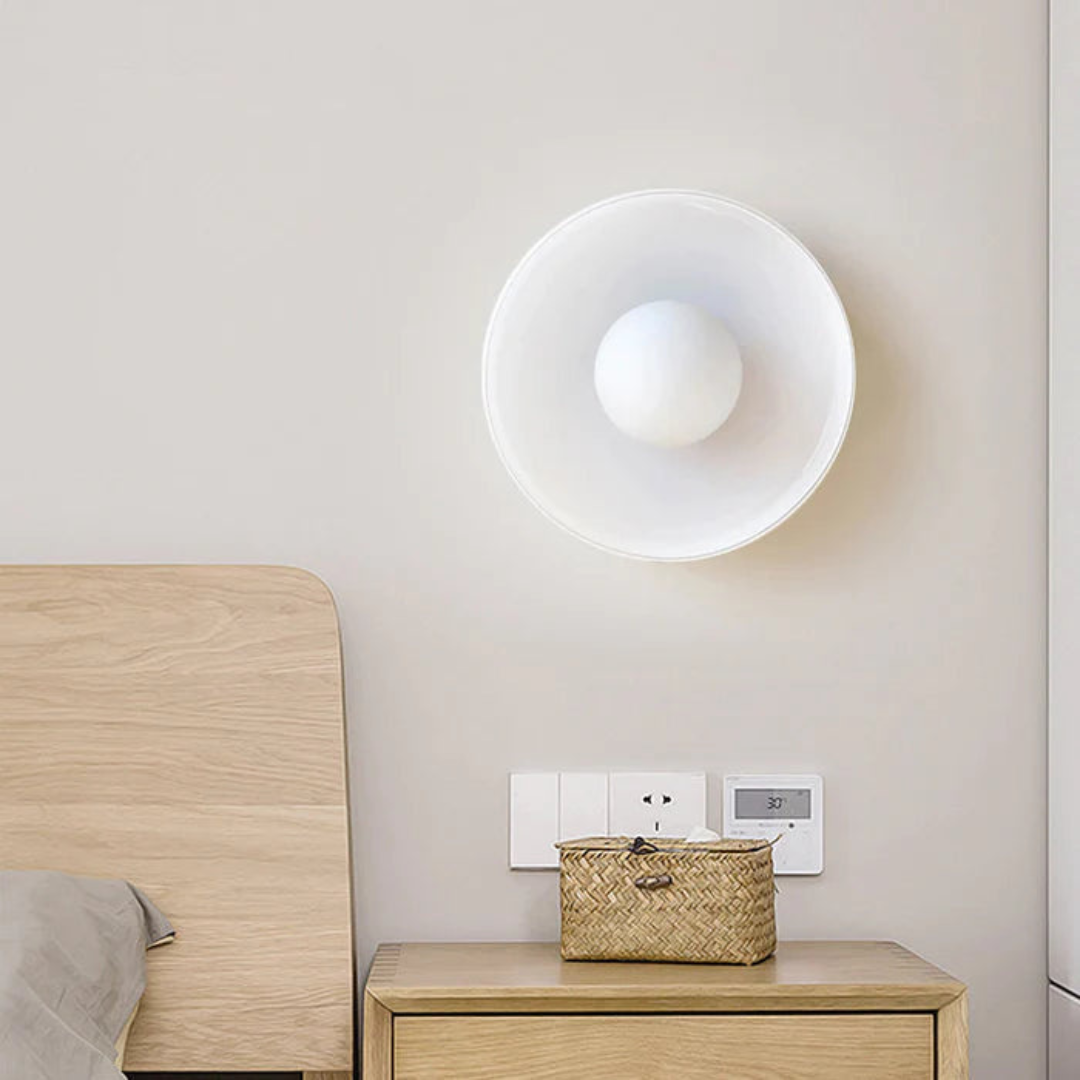 Modern LED ceiling light, white circular disc with inner sphere above a wooden nightstand on Tampa Home & Garden Store