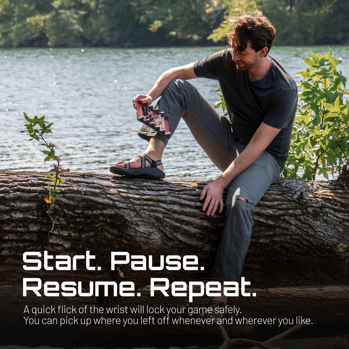 Mini Chess - Fire chess set by VentureBoard, compact red board, held by man on a log by a lake on Tampa Home & Garden Store
