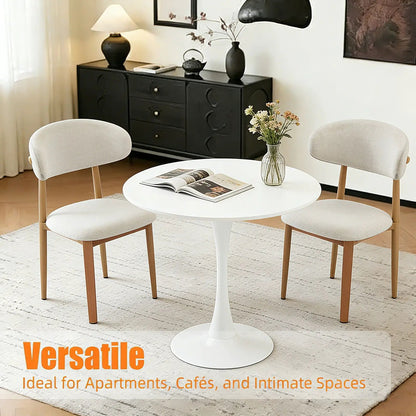 Round dining table with tulip-style white pedestal base by Unique Piece Furniture, beige chairs on Tampa Home & Garden Store
