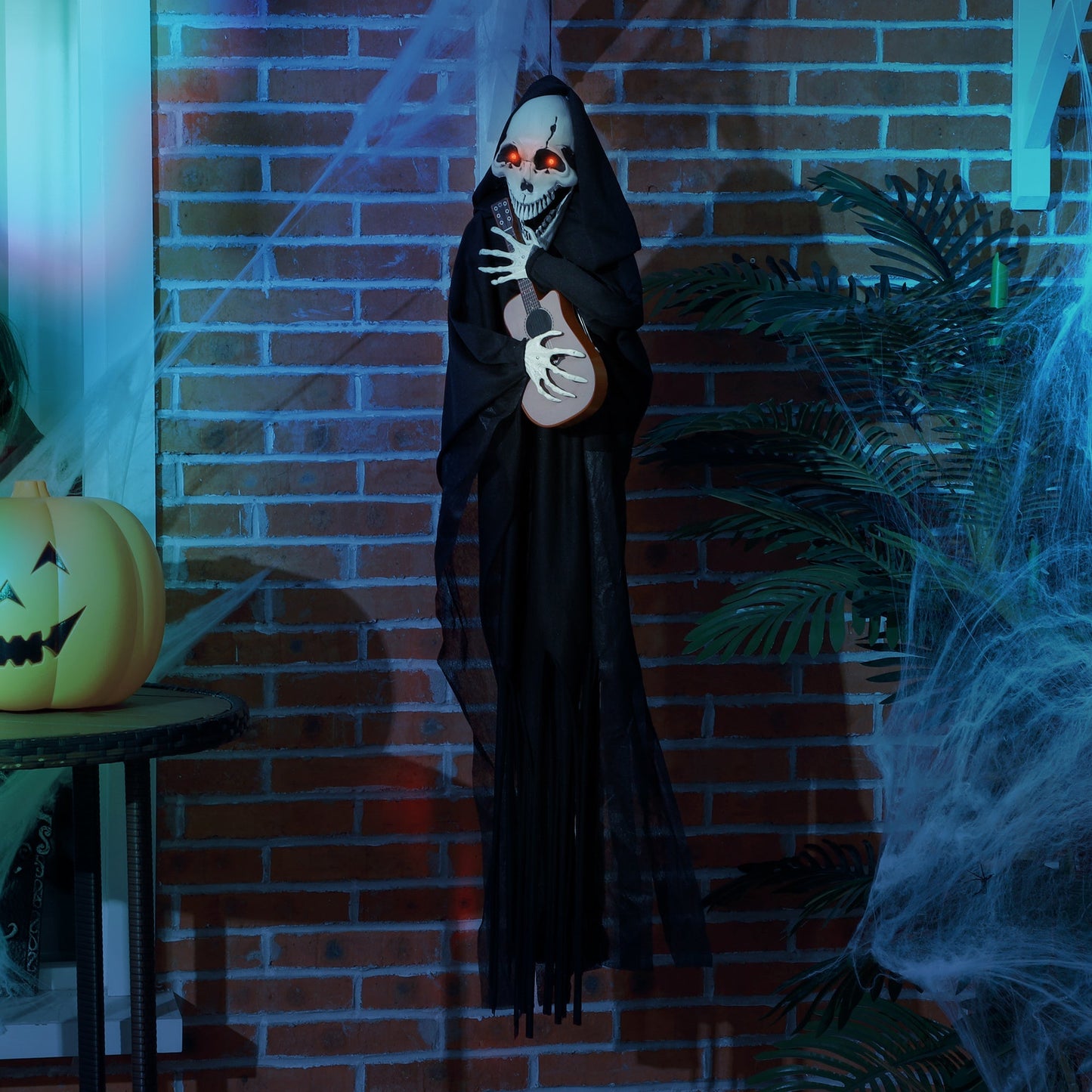 4.3' Animated Grim Reaper guitarist in black cloak with glowing red eyes, guitar in hand on Tampa Home & Garden Store