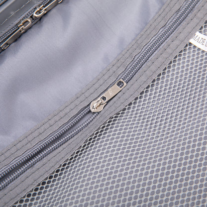 Luggage interior close-up in light gray with mesh pocket and metal zippers on Tampa Home & Garden Store