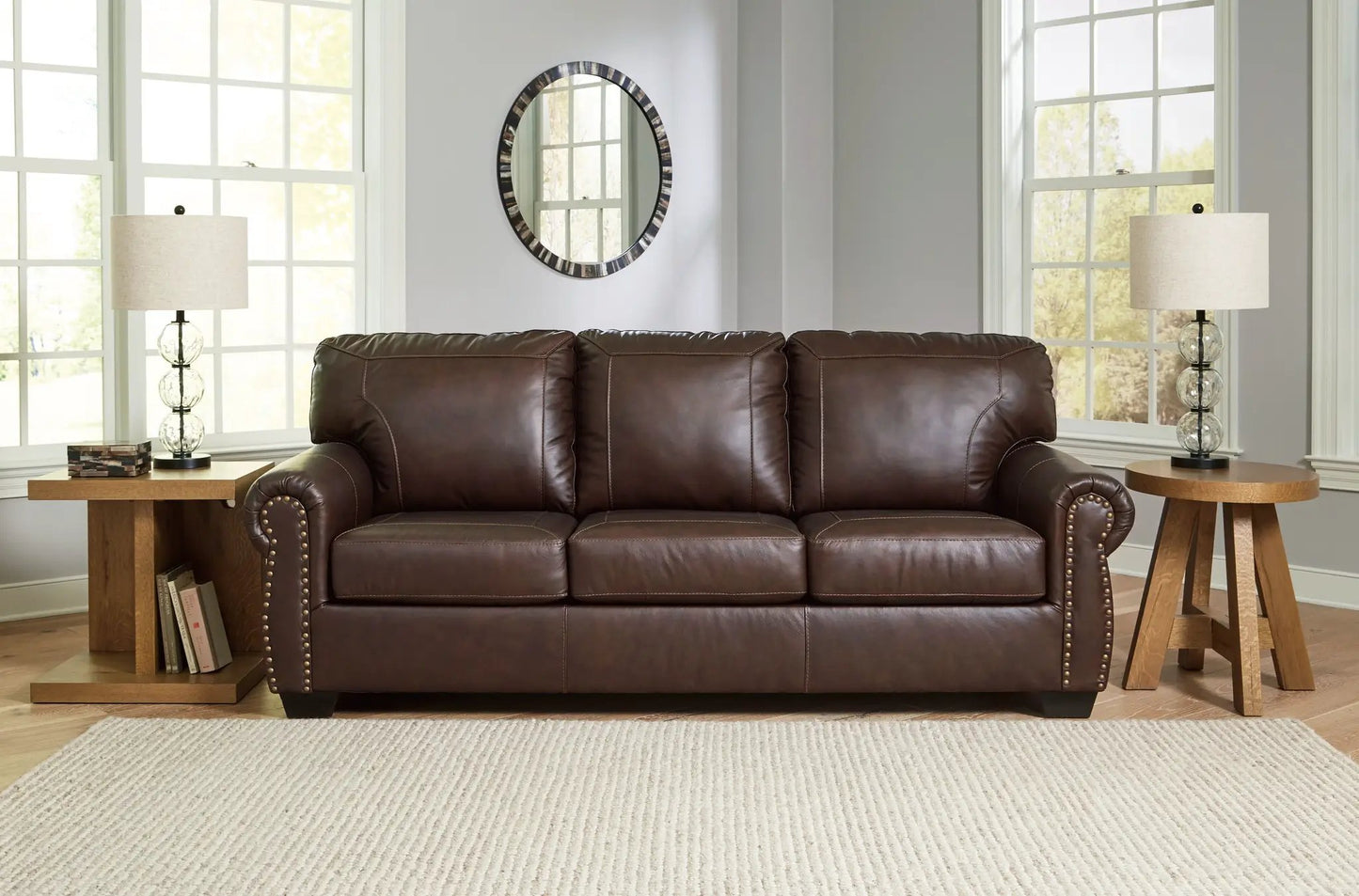 Colleton dark brown leather stationary sofa with nailhead trim in a bright living room on Tampa Home & Garden Store