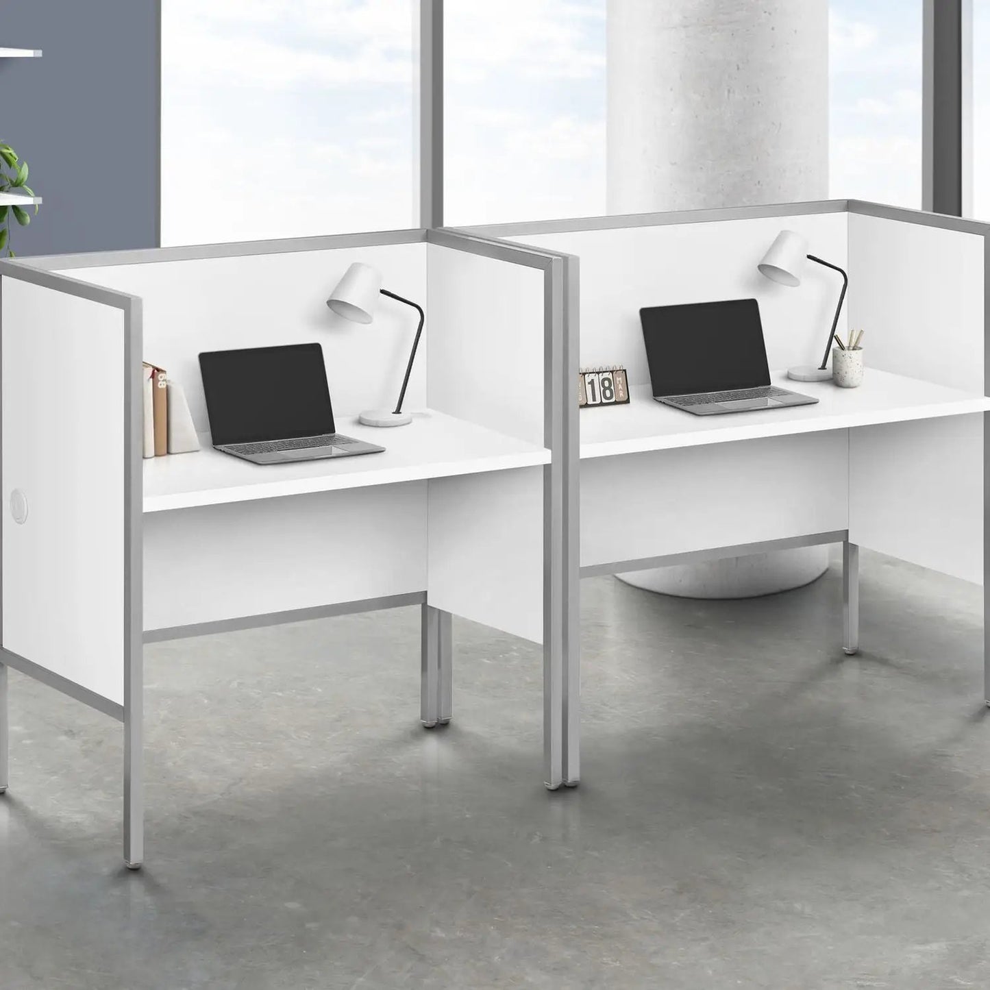 Two white office cubicle work stations with metal frames, laptops and modern desk lamps on Tampa Home & Garden Store